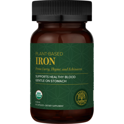 Brown supplement bottle with green label on a white background