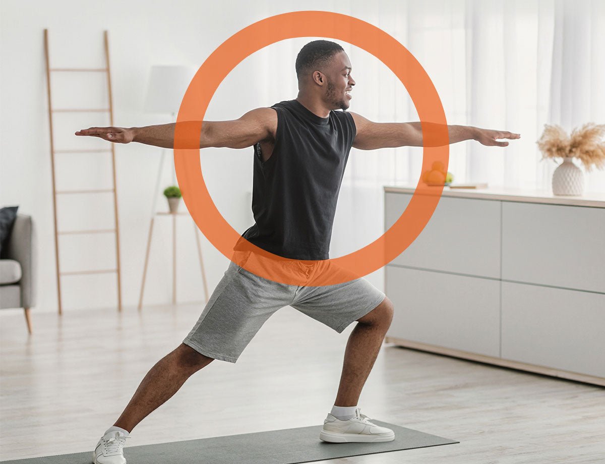 A person doing a yoga warrior pose in a bright, plant-filled living room.
